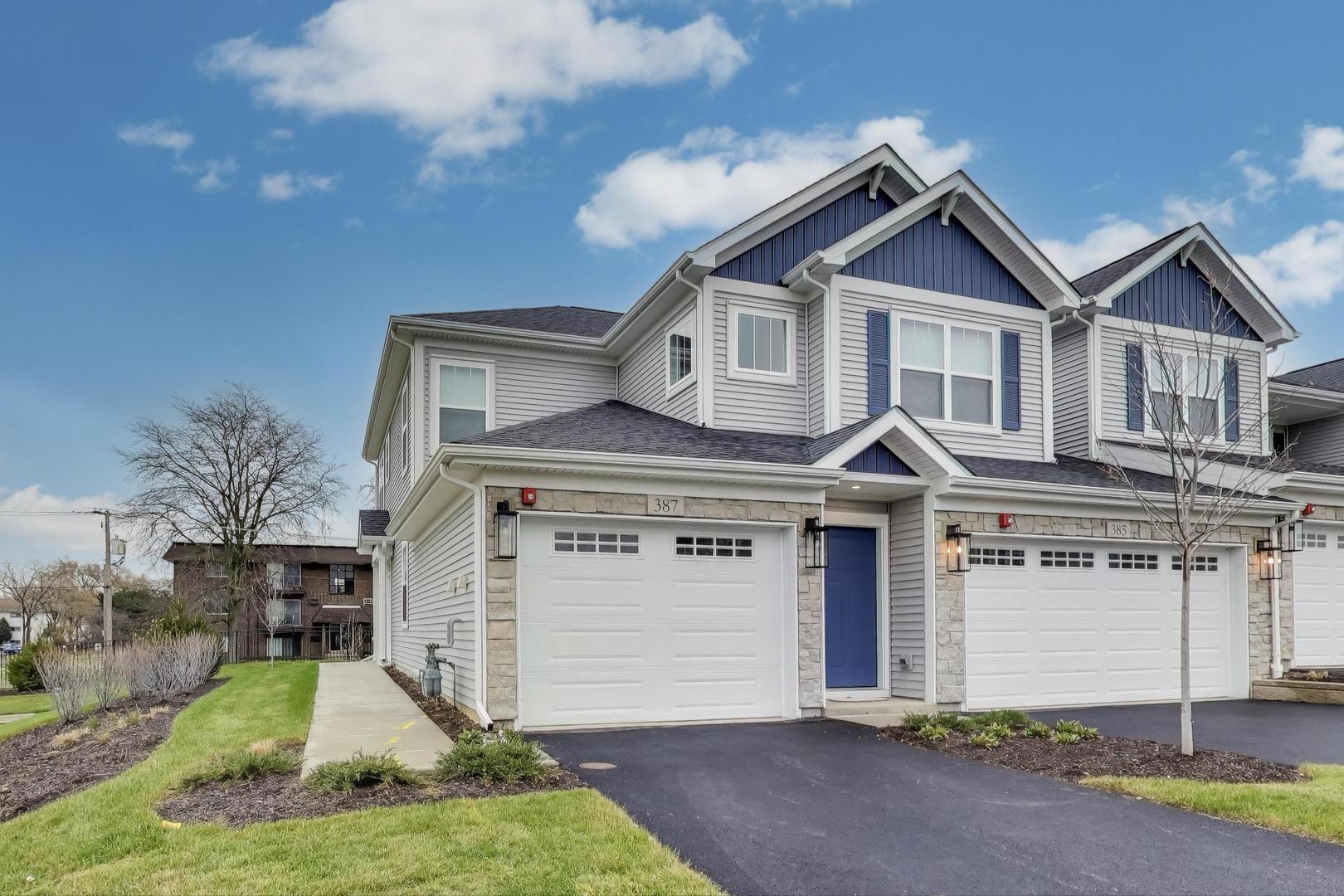 387 Masters Drive Addison, IL 60101 - Photo 1 of 26 a front view of a house with a yard and garage