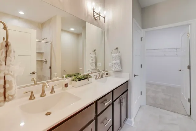 a bathroom with a sink tub vanity and a mirror