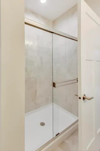 a bathroom with a glass shower door