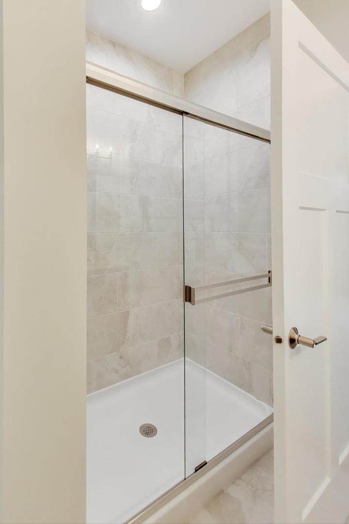 387 Masters Drive Addison, IL 60101 - Photo 13 of 26 a bathroom with a glass shower door