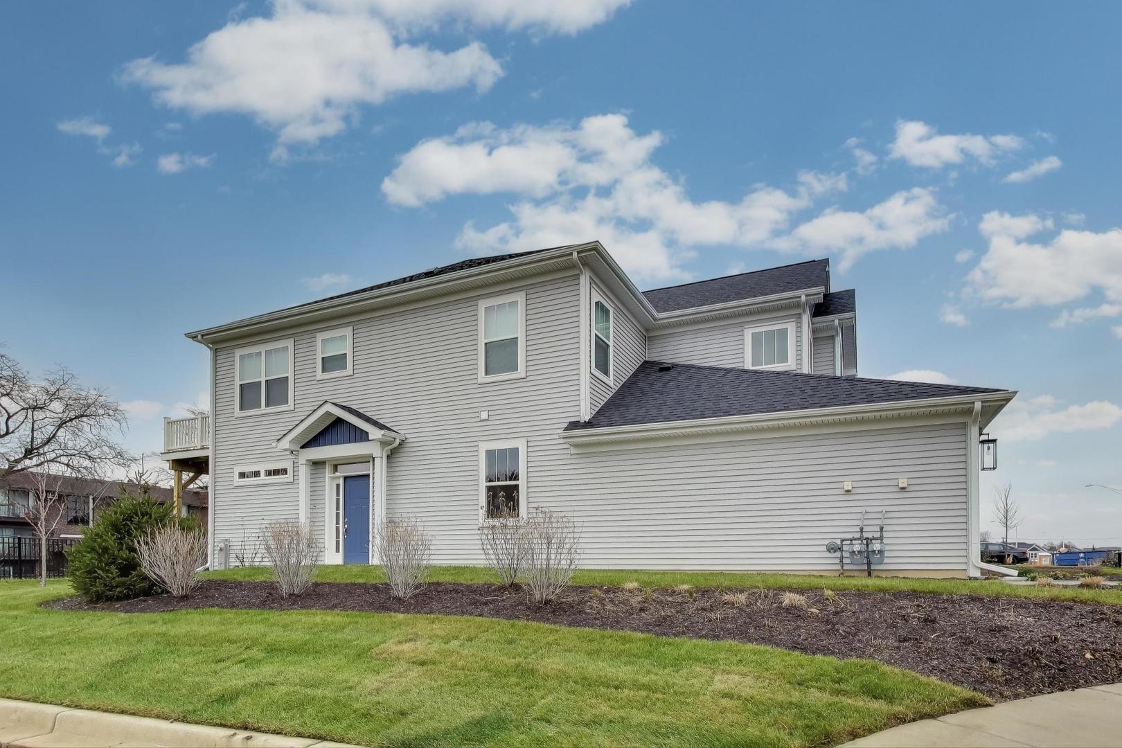 387 Masters Drive Addison, IL 60101 - Photo 24 of 26 a front view of a house with a yard and garage