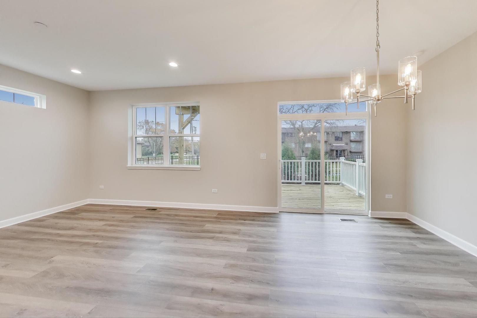 387 Masters Drive Addison, IL 60101 - Photo 6 of 26 a view of livingroom with hardwood floor and window