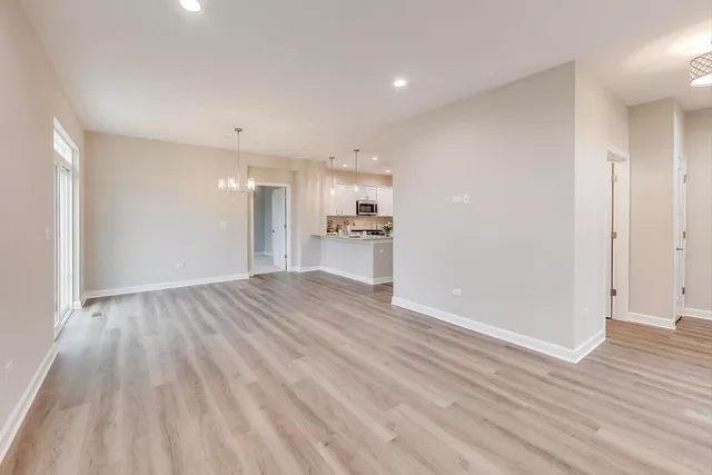 a view of a kitchen with wooden floor and a kitchen