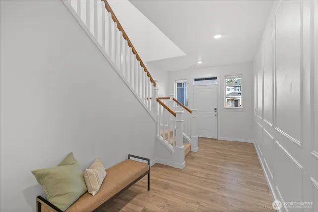 a view of entryway and hall with wooden floor