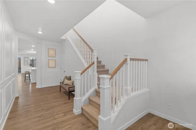 a view of entryway and hall with wooden floor