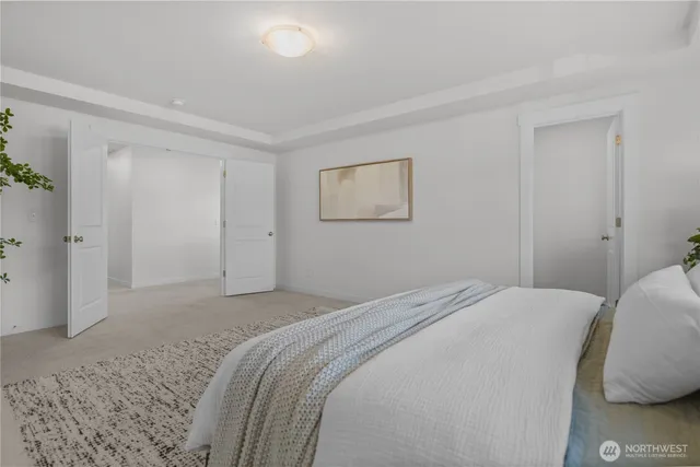 a bedroom with a bed and hallway