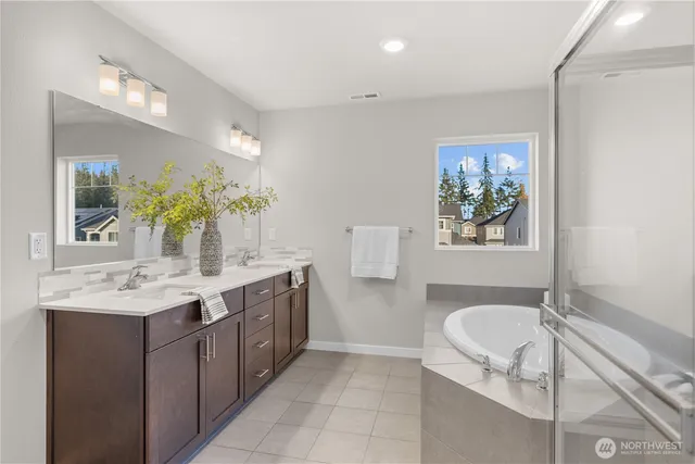a spacious bathroom with a granite countertop sink mirror and bathtub