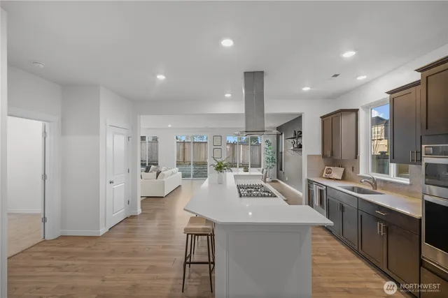 a large kitchen with a large counter top appliances and cabinets