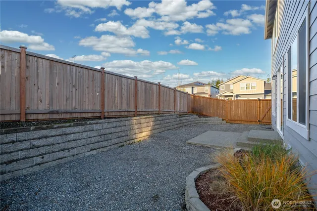 a view of a house with a backyard and a garden