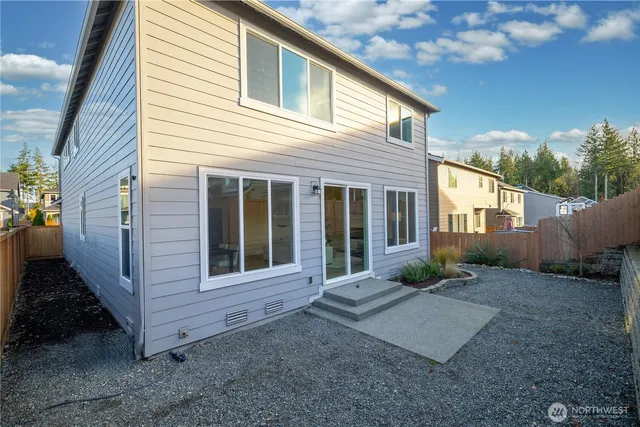 a view of room that has white walls and dresser