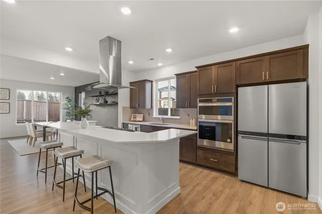a kitchen with stainless steel appliances a refrigerator and a stove top oven