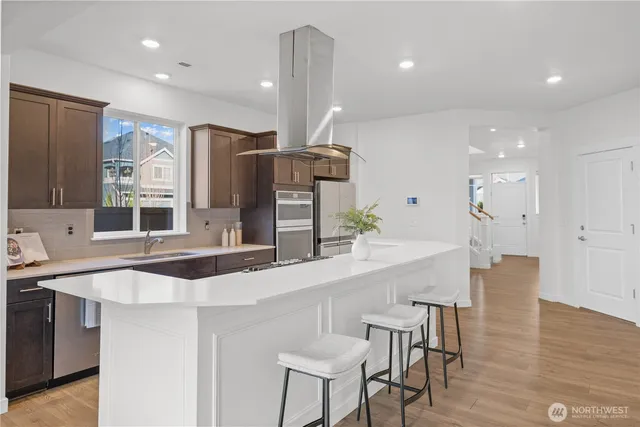 a kitchen with stainless steel appliances a sink and a refrigerator