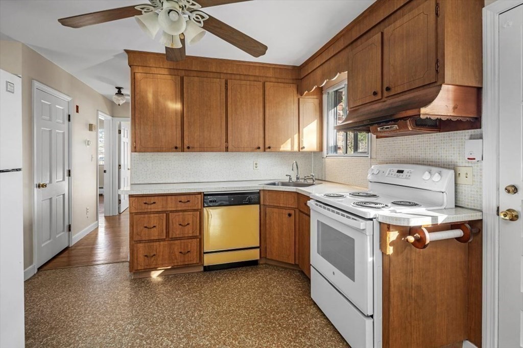 48 Fuller Road Wayland, MA 01778 - Photo 11 of 38 a kitchen with stainless steel appliances granite countertop a stove a sink and a refrigerator