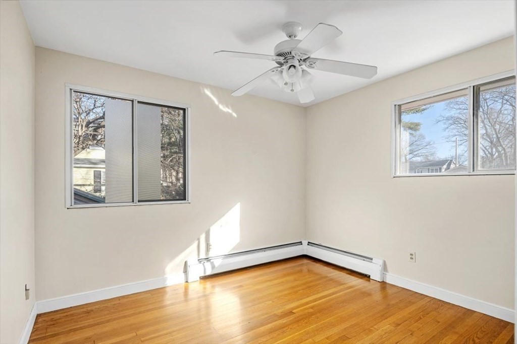 48 Fuller Road Wayland, MA 01778 - Photo 15 of 38 a view of an empty room with wooden floor and a window