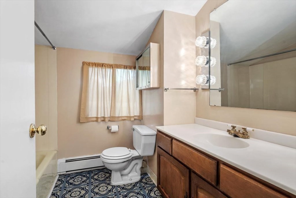 48 Fuller Road Wayland, MA 01778 - Photo 24 of 38 a bathroom with a granite countertop sink a toilet and a mirror