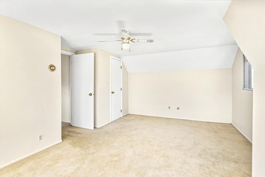 48 Fuller Road Wayland, MA 01778 - Photo 26 of 38 an empty room with a chandelier fan and windows