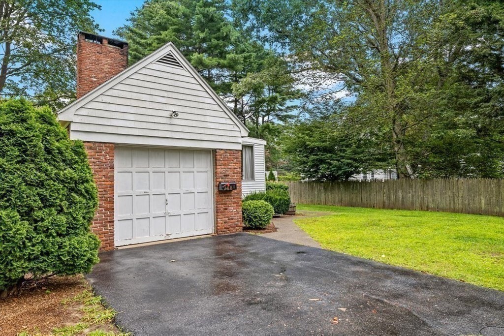 48 Fuller Road Wayland, MA 01778 - Photo 31 of 38 a front view of a house with a yard and garage