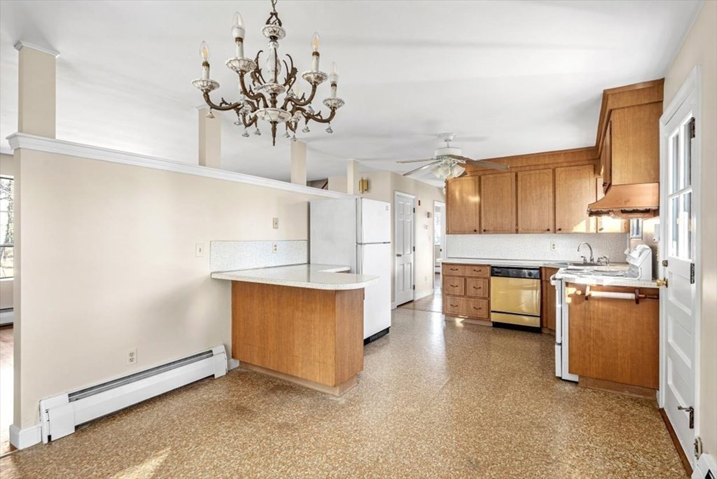 48 Fuller Road Wayland, MA 01778 - Photo 9 of 38 a kitchen with stainless steel appliances a stove a sink and cabinets