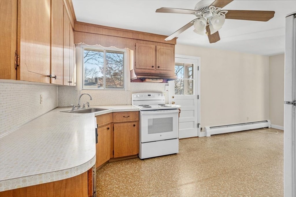 48 Fuller Road Wayland, MA 01778 - Photo 10 of 38 a kitchen with white cabinets and white appliances