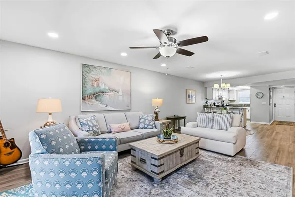 a living room with furniture and a chandelier