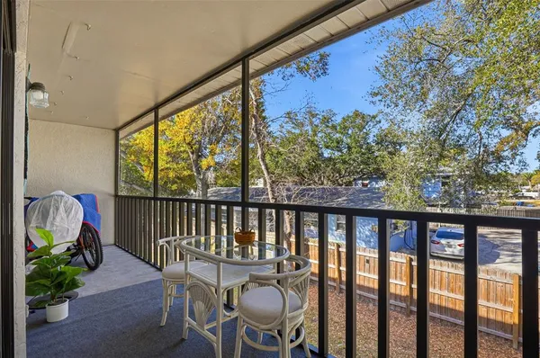 a view of a balcony with furniture