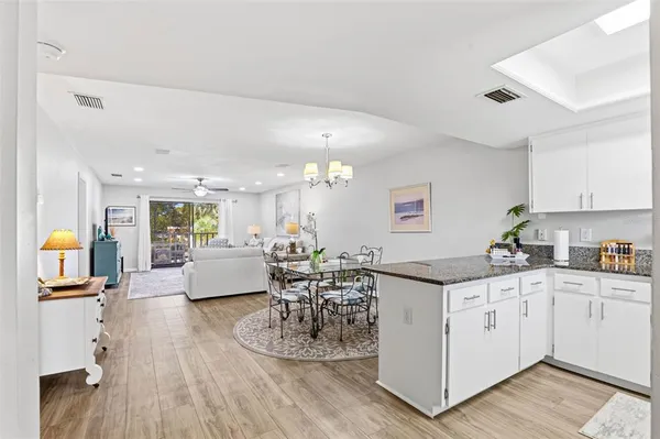 a kitchen with stainless steel appliances granite countertop a stove and a wooden floors