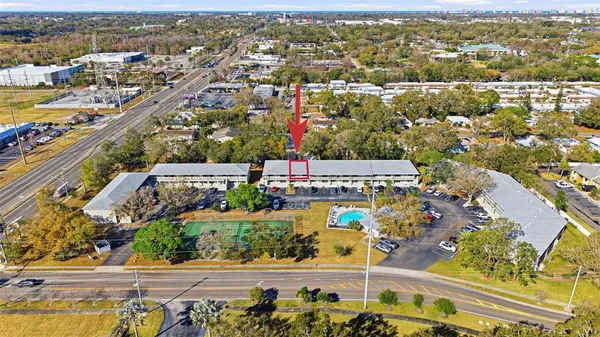 an aerial view of residential building with parking