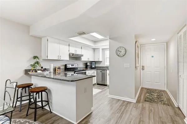 a kitchen with stainless steel appliances granite countertop a sink and cabinets