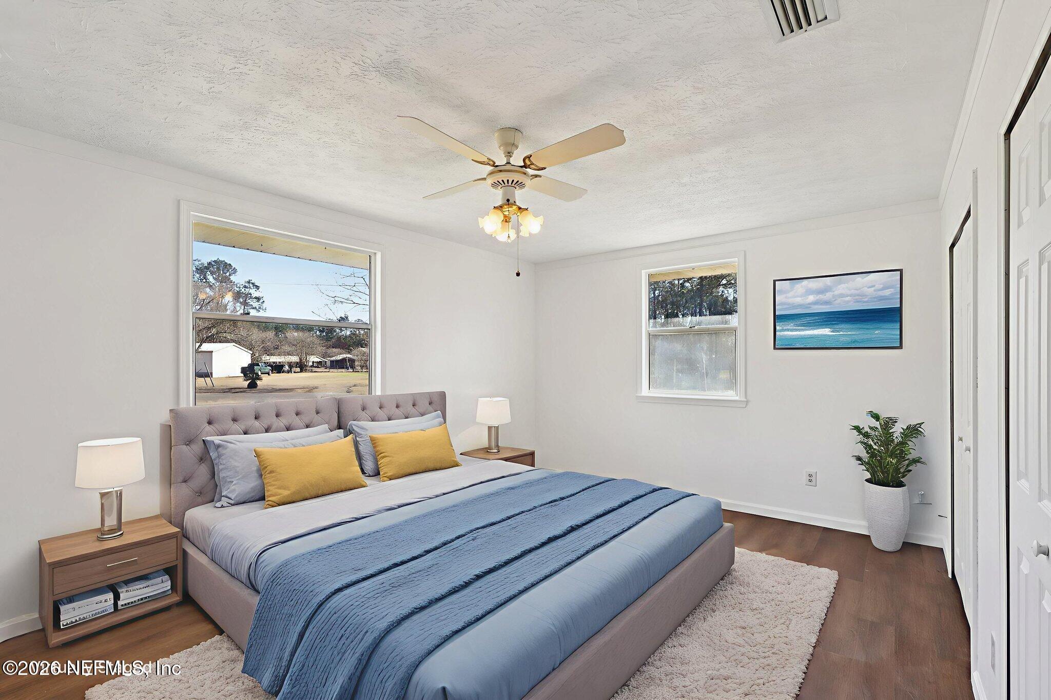 54031 Sheffield Road Callahan, FL 32011 - Photo 18 of 56 a bedroom with a large bed and a window