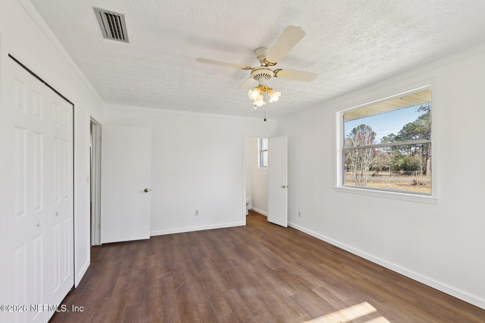 54031 Sheffield Road Callahan, FL 32011 - Photo 27 of 59 wooden floor in an empty room with a window