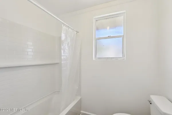 an empty room with wooden floor a ceiling fan and closet
