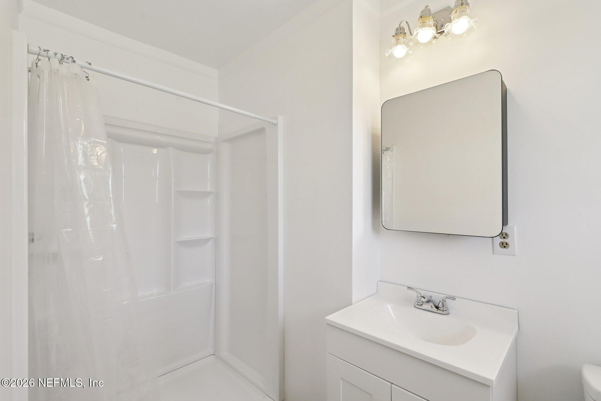54031 Sheffield Road Callahan, FL 32011 - Photo 29 of 59 a bathroom with a sink a mirror and vanity