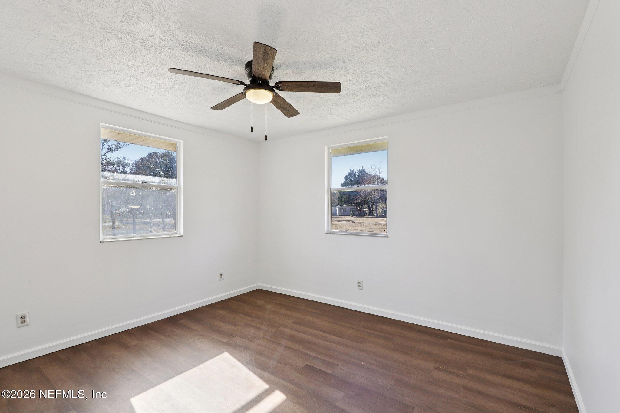 54031 Sheffield Road Callahan, FL 32011 - Photo 30 of 56 a view of empty room with wooden floor