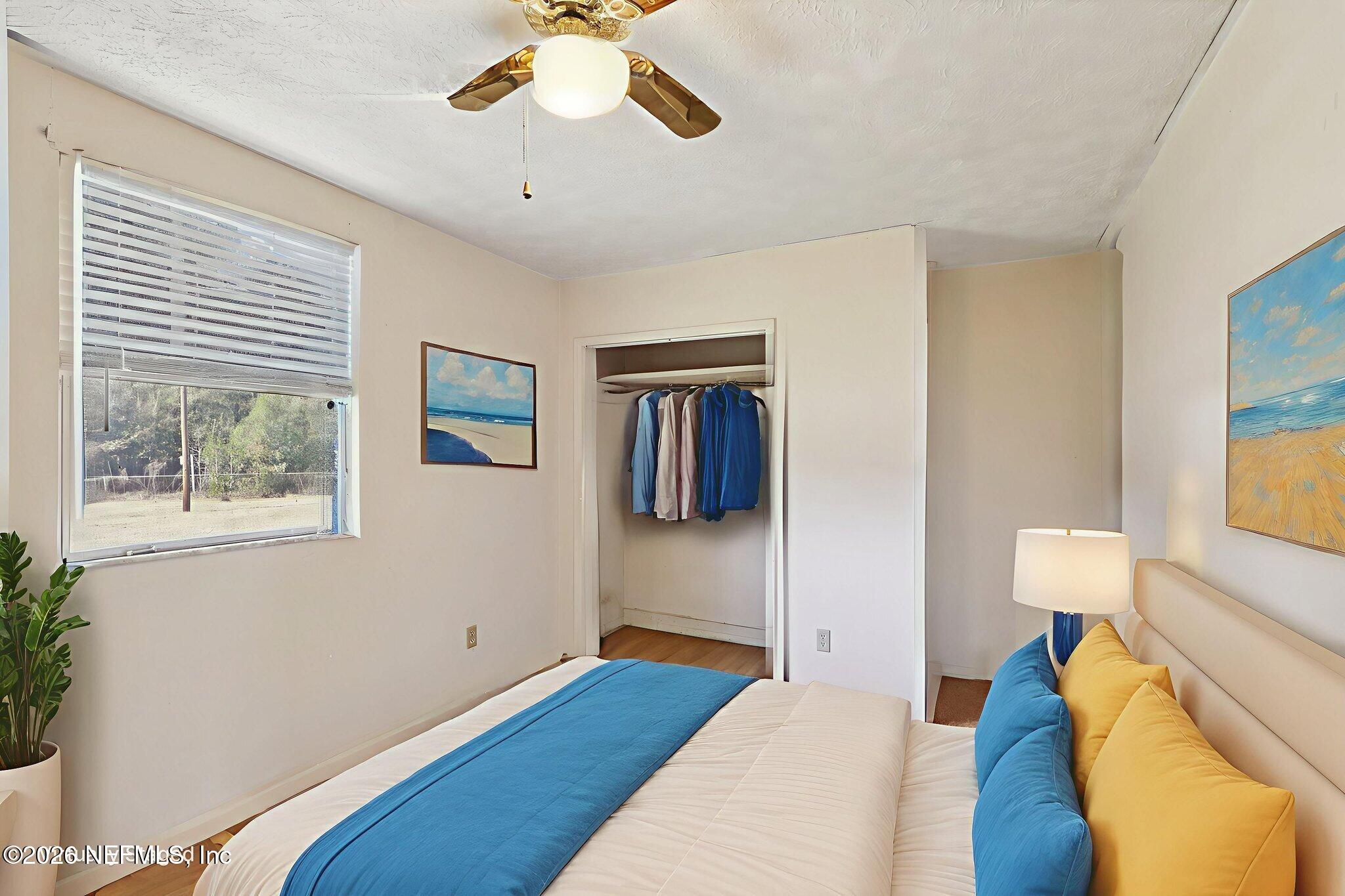 54031 Sheffield Road Callahan, FL 32011 - Photo 30 of 59 a bedroom with a bed and a chandelier