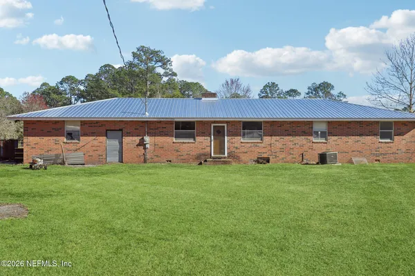 a view of a house with a yard and sitting area