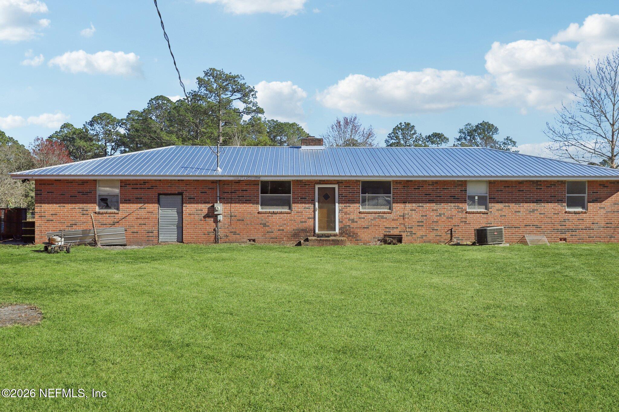54031 Sheffield Road Callahan, FL 32011 - Photo 41 of 59 a front view of a house with a garden