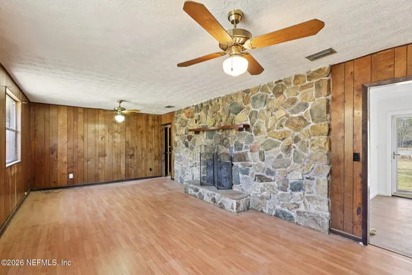 a view of an empty room with wooden floor