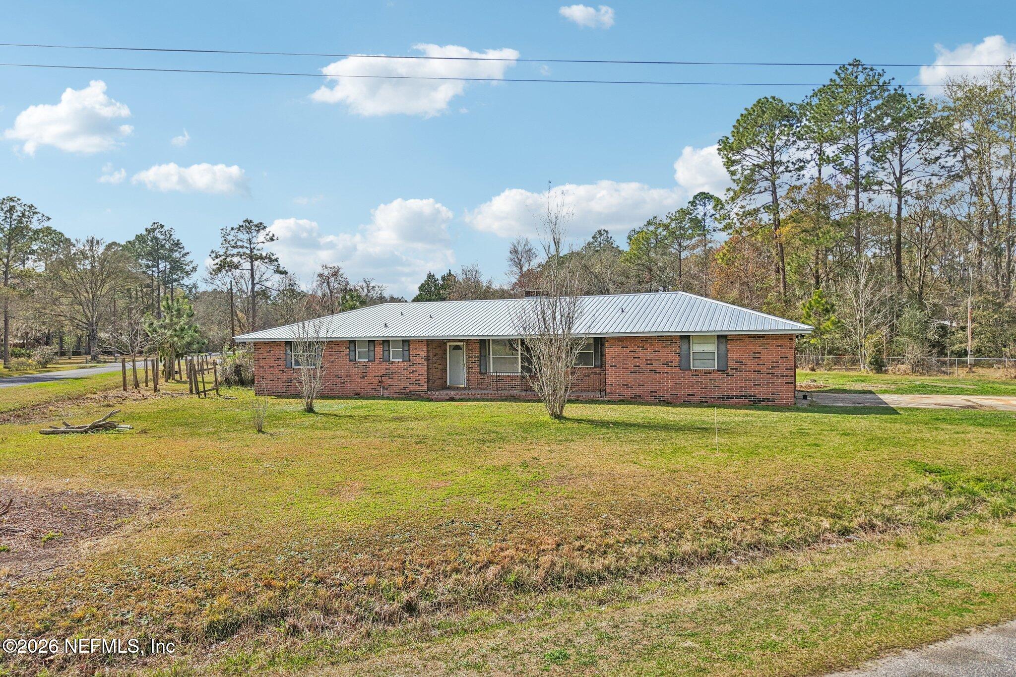 54031 Sheffield Road Callahan, FL 32011 - Photo 55 of 56 a view of a house with a yard and a large pool
