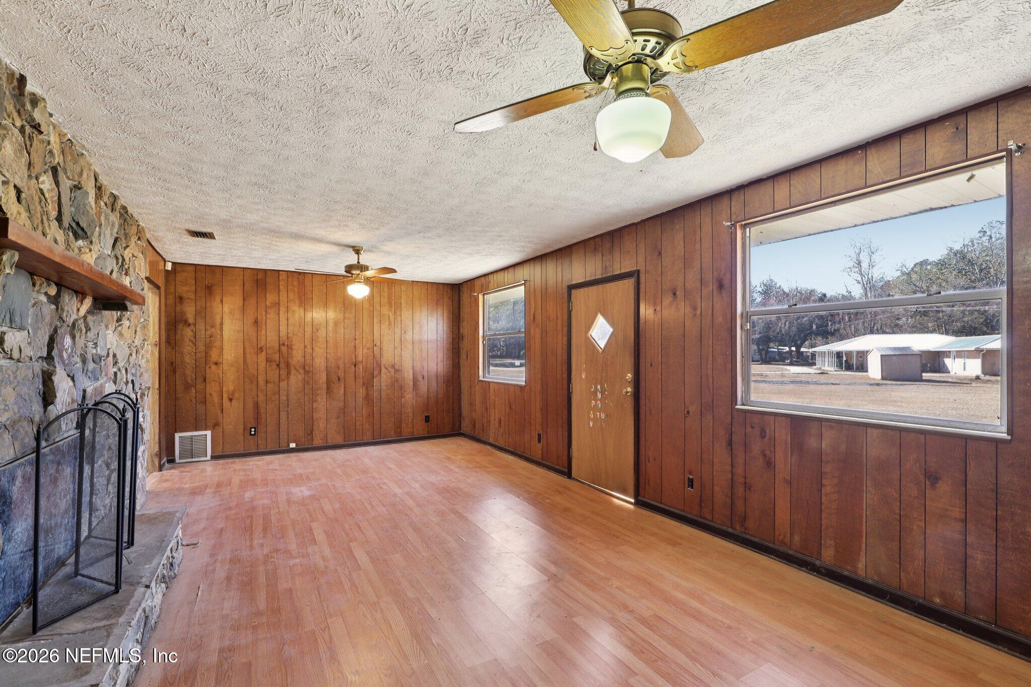 54031 Sheffield Road Callahan, FL 32011 - Photo 10 of 59 a view of an empty room with a window and wooden floor