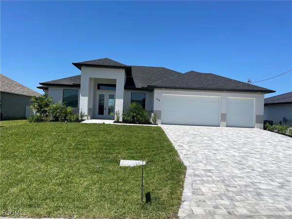 a front view of a house with a yard