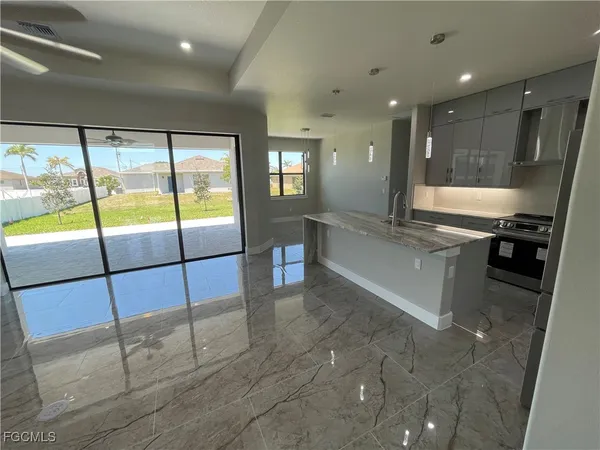 a large kitchen with a large window and kitchen view