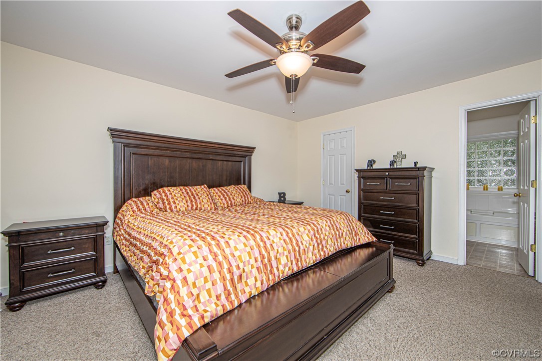 4230 Gayle Road Chester, VA 23831 - Photo 27 of 28 a bedroom with a bed and a chandelier