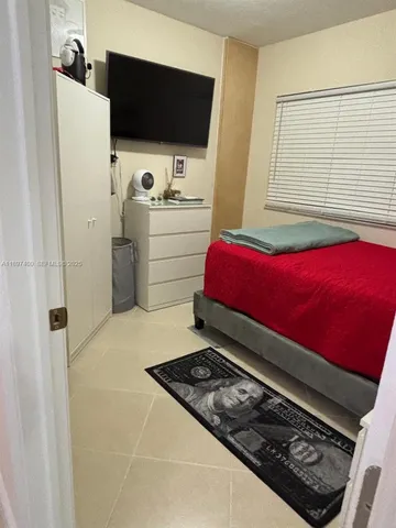 a bedroom with a bed and a chair