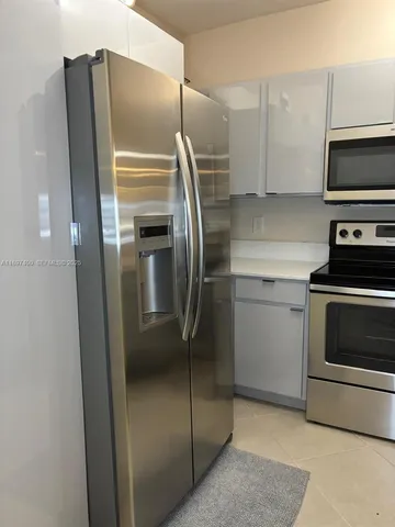 a kitchen with a refrigerator sink and microwave