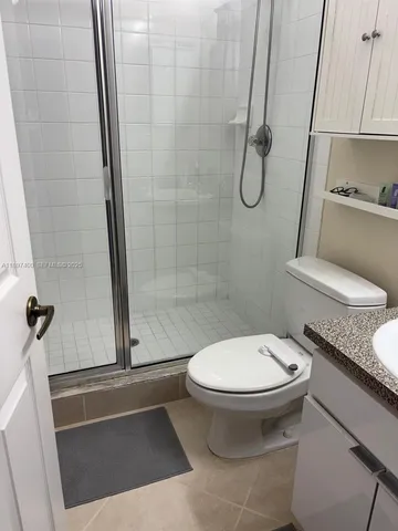 a bathroom with a toilet and a shower