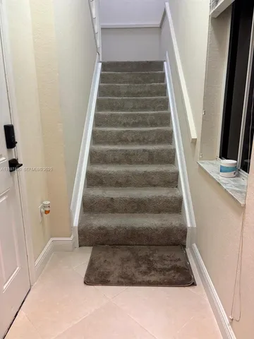 a view of staircase with white walls