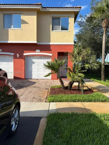 a view of a car parked front of a house