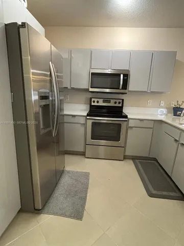 a kitchen with stainless steel appliances a refrigerator and a sink