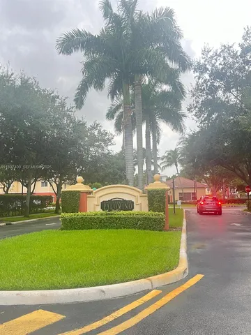 a view of a swimming pool and a yard in the background