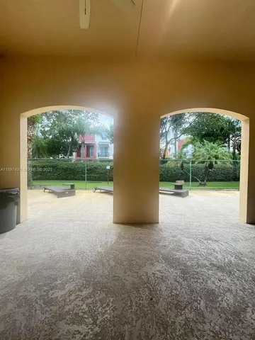 a backyard of a house with table and chairs